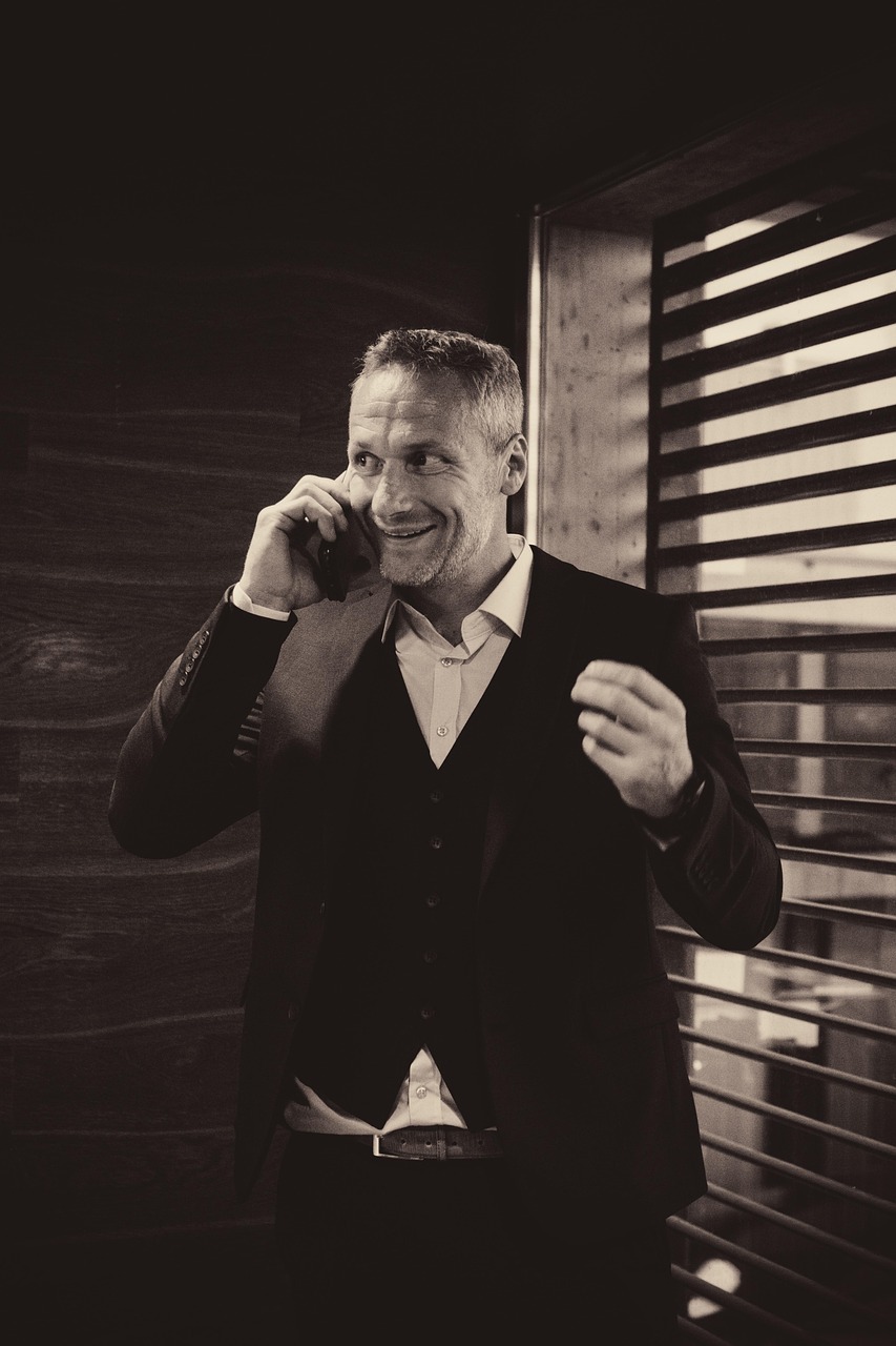 A man having a serious phone conversation, representing the awkward task of enforcing a cancellation policy